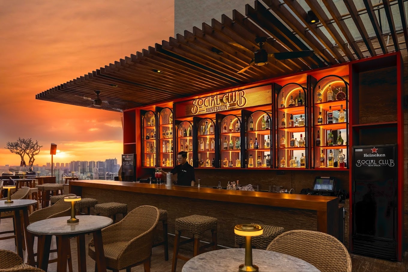 The glowing gold-lit bar invites guests to watch the finesse of skilled bartenders up close